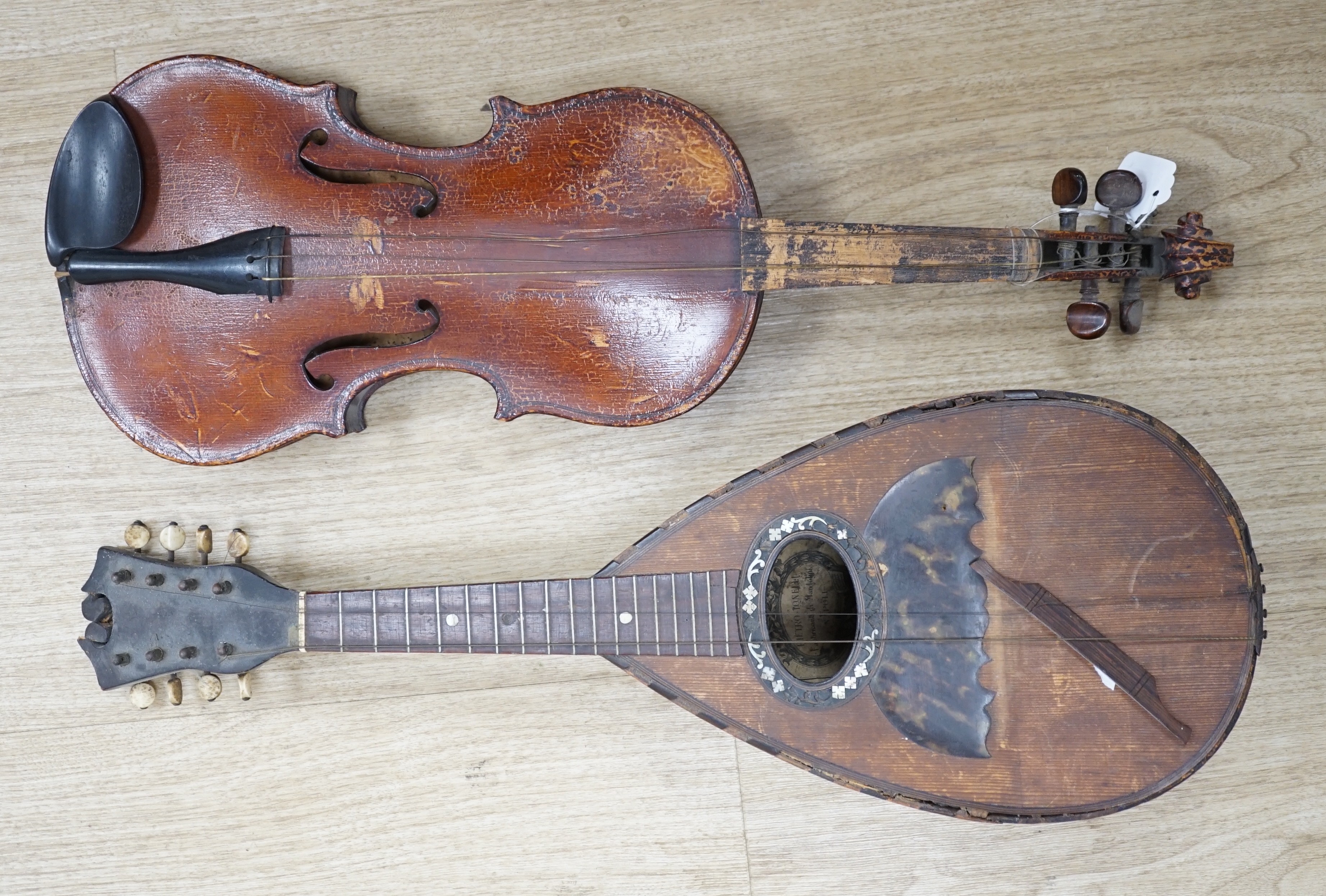 An Italian balloon back mandolin with tortoiseshell overlay, circa 1900, label for Pietro Tonelli of Napoli together with a violin, interior hand label reads ‘A.J. Newland London SW12 1939’ length of violin back excludin